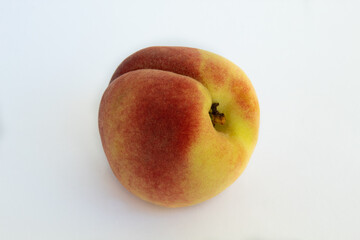 Close up of peach on white background