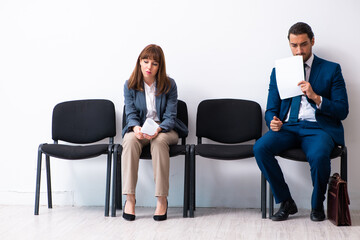 Young businessman and businesswoman waiting for an interview at