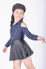 Portrait of cute casual smiling asian girl 8-9 year old posing and looking at camera isolated on...