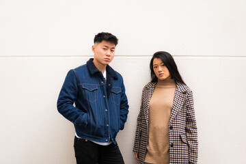 Young asian couple looking at camera confidently.