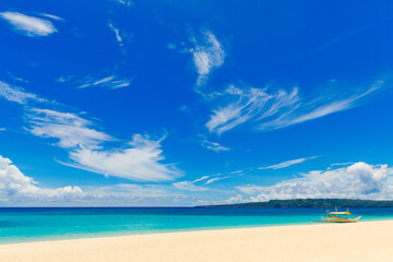 Fototapeta na wymiar Beautiful sky with clouds under tropical beach on Boracay island, Philippines. Sea, sailboat and white sand. Nature view. Summer vacation concept.