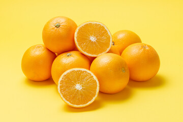 Orange fruit  isolated over yellow background. Whole and sliced orange. 
