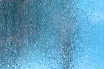 Condensation on the clear glass window. Water drops. Rain. Abstract background texture