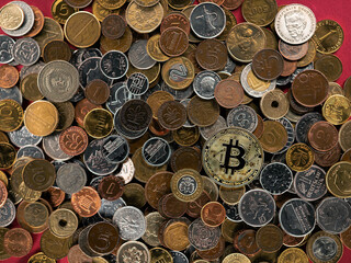 A lot of metal money from different countries, one bitcoin.