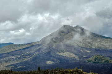 Gunung Batur is active volcano in the tropical island of Bali. The height of the volcano is 1717 meters