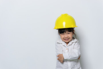 Portrait of cute asian little girl in engineer uniform and helmet on white background