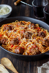 Meatballs with spaghetti, tomato sauce and parmesan cheese. Italian cuisine.