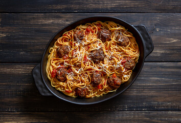 Meatballs with spaghetti, tomato sauce and parmesan cheese. Italian cuisine.
