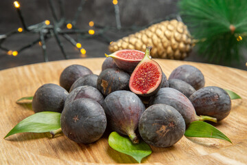 front view fresh figs inside plate around toys on dark background fruit dark taste xmas photo