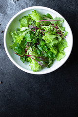 salad green mix leaves vitamins ready to cook and eat on the table for making healthy meal snack top view copy space for text food background rustic image keto or paleo diet
