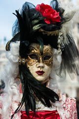 Venice, Italy - February 16, 2020: An unidentified person in a carnival costume in Piazza San Marco attends at the Carnival of Venice.