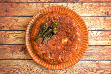 Spanish omelette on wooden background top view