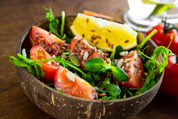  Healthy microgreen salad with tomatoes and seeds close-up