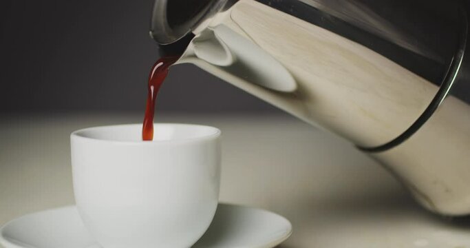 Closeup shot of coffee pour into cup from geyser coffee maker