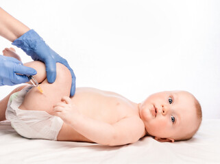Doctor injecting a vaccine in leg of baby boy