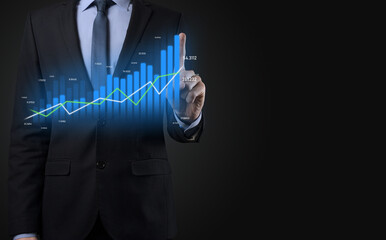 Business man holding holographic graphs and stock market statistics gain profits. Concept of growth planning and business strategy. Display of good economy form digital screen.