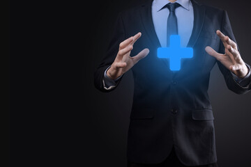 Businessman, man hold in hand offer positive thing such as profit, benefits, development, CSR represented by plus sign.The hand shows the plus sign