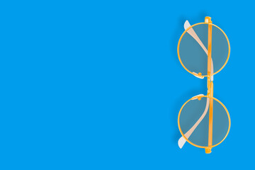 Background on the theme of glasses for vision. Glasses seamless pattern on a blue background.