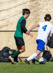 Young athletic boy competing in a soccer game