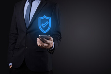 Protection network security computer in the hands of a businessman. business, technology, cyber security and internet concept - businessman pressing shield button on virtual screens Data protection