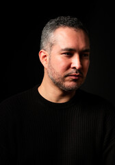 Fototapeta premium Portrair of a young man over a black background