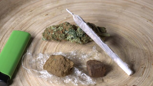 Europe, Italy , Milan - Weed marijuana e hashish thc drug - more and more young millennials use joint drugs during the Covid-19 Coronavirus epidemic - rolling  a joint to smoke 