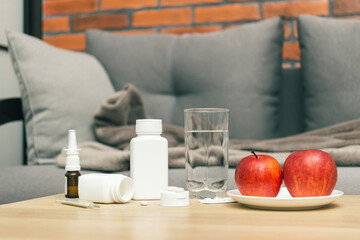 Treatment virus infection, coronavirus, covid-19 in home concept, table with medication in room with sofa