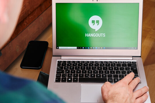 Google Hangouts is used for business meeting on laptop by man. An illustrative editorial image. San Francisco, US, June 2020.