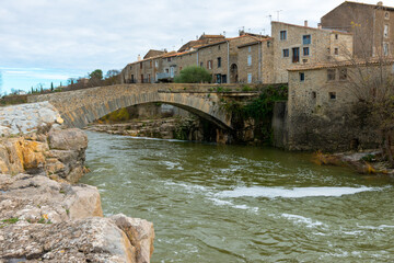 Fototapeta premium The pretty town of Ribaute in the South of France with the River Orbieu