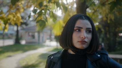 Young woman on the street during pandemic period and she is taking off her black mask and breathing and while looking at camera. Covid-19 concept