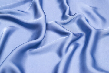 Obraz premium Blue silk or satin luxury fabric texture. Top view.