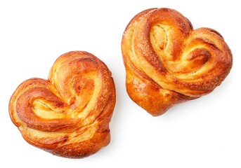 Yeast dough buns in the form of a heart on a white background, isolated. The view from top