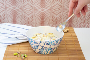 Healthy breakfast of a bowl with yogurt, seeds, fruits and nuts