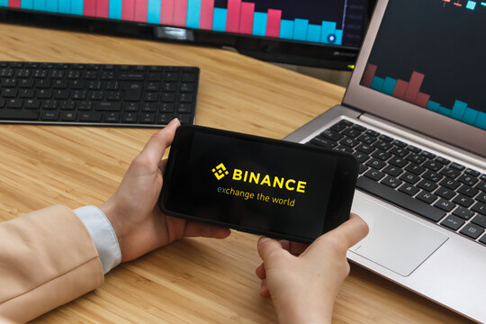 SAN FRANCISCO, US - 18 June 2019: Female Trader Hands Holding the Smartphone Using Application of Binance Cryptocurrency Exchange Market. San Francisco, California, USA