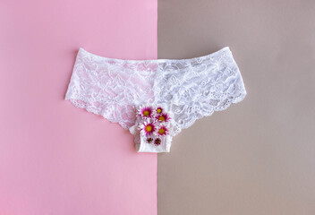 women's white underpants on a combined two-color background, the concept of menstruation in women, top view
