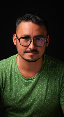 Portrair of a young man over a black background