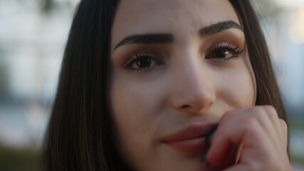 Close up portrait of a young woman on the street happy eyes looking into the camera. Flirt emotions