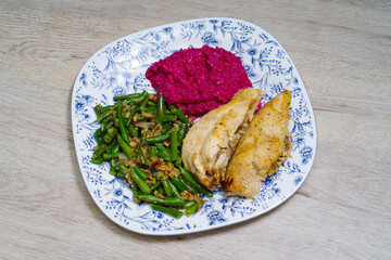 Chicken breast with beetroot sauce garnished with green beans and walnuts