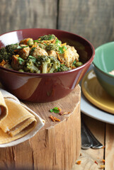 Soy goulash, protein food with stewed vegetables: pea, broccoli, carrot and spices, healthy vegan meal - a source of proteins, closeup, copy space