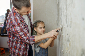 Fototapeta na wymiar Father with kid repairing room together and unhanging wallpaper together