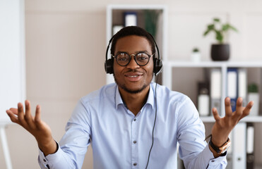 Portrait of african american man in headset talking and gesturing