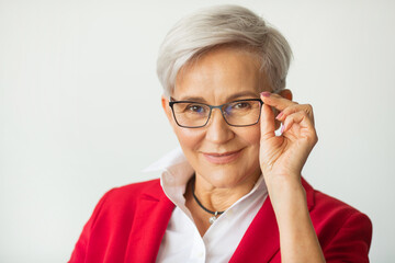 beautiful stylish woman aged in a red jacket with glasses