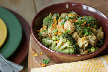 Soy goulash, protein food with stewed vegetables: pea, broccoli, carrot and spices, healthy vegan meal - a source of proteins, closeup, copy space