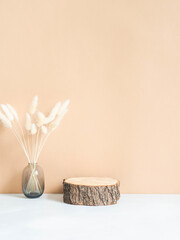 Natural wood podium and dry flowers in glass vase