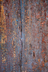 background of an old dark  painted wooden wall of planks wiht knots and cracks