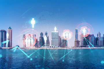 Skyscrapers of Dubai business downtown. International hub of trading and financial services. Social network icons hologram, concept of people connection. Double exposure. Dubai Canal waterfront.