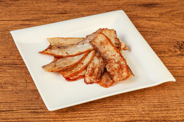 Roasted juicy bacon in the plate