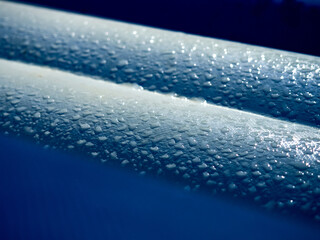 Random water drops on the blue PVC surface
