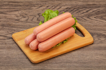 Tasty meat sausages over board