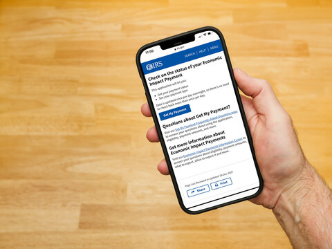 ATLANTA, GEORGIA - December 21, 2020 : Checking Status Of Economic Impact Payment Online At The Irs.gov Website Using Smart Cell Phone. Stimulus Check For Coronavirus COVID-19 Pandemic Relief.